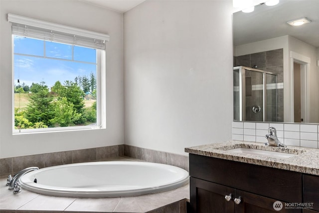 2719 Fiddleback St NE, Lacey, WA 98516 - bathroom with vanity, a shower stall, a garden tub, and tasteful backsplash