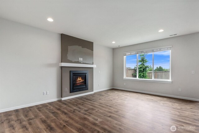 2719 Fiddleback St NE, Lacey, WA 98516 - unfurnished living room featuring a large fireplace, wood finished floors, baseboards, and recessed lighting