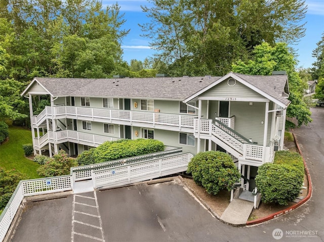 12315 NE 97th St Unit G, Kirkland, WA 98033 - view of building exterior featuring stairway and view of wooded area