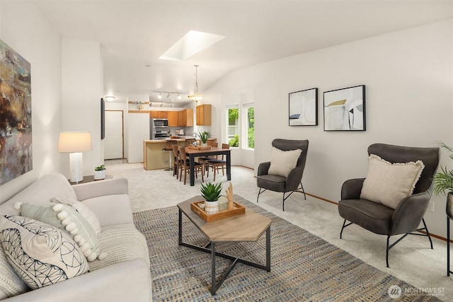 12315 NE 97th St Unit G, Kirkland, WA 98033 - living room featuring a skylight, light colored carpet, and lofted ceiling