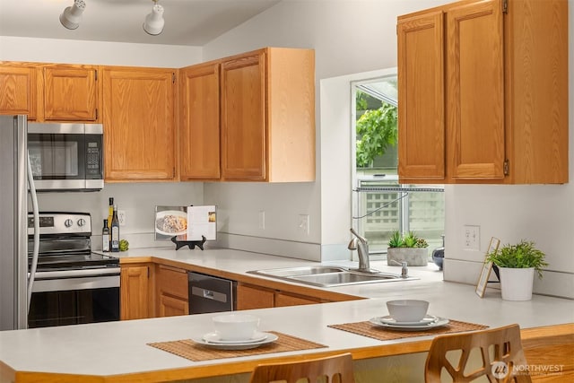 12315 NE 97th St Unit G, Kirkland, WA 98033 - kitchen featuring stainless steel appliances, light countertops, and a peninsula