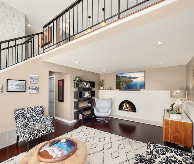 13117 NE 128th Pl NE, Kirkland, WA 98034 - living area featuring wood finished floors, a lit fireplace, recessed lighting, a towering ceiling, and stairs