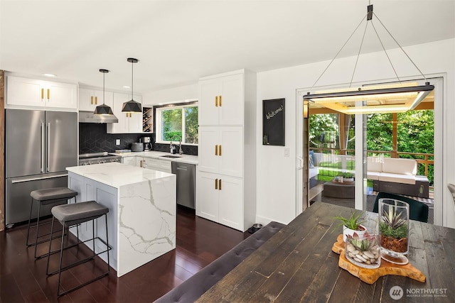 13117 NE 128th Pl NE, Kirkland, WA 98034 - kitchen with appliances with stainless steel finishes, exhaust hood, dark wood finished floors, a sink, and decorative backsplash