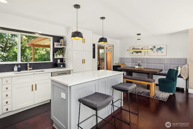 13117 NE 128th Pl NE, Kirkland, WA 98034 - kitchen featuring a sink, a kitchen island, decorative backsplash, white cabinets, and dark wood-style floors
