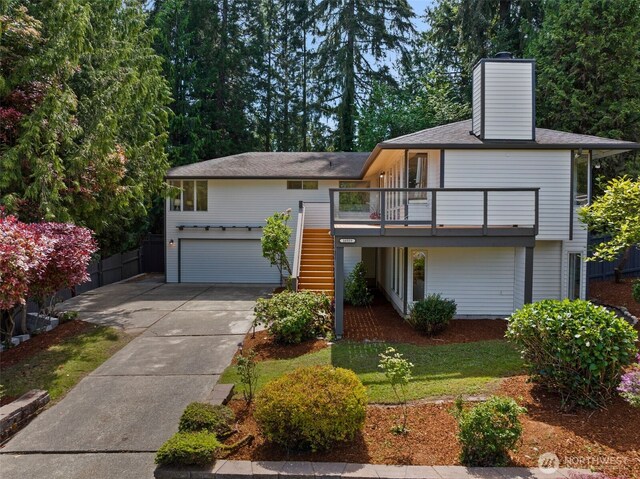 16939 SE 39th St, Bellevue, WA 98008 - view of front of property with stairway, a chimney, driveway, and an attached garage