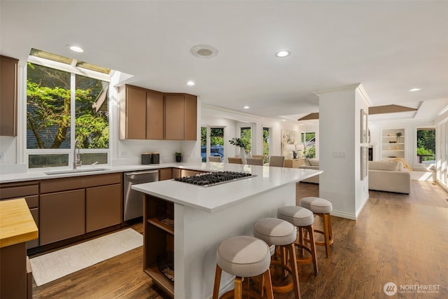 16939 SE 39th St, Bellevue, WA 98008 - kitchen featuring appliances with stainless steel finishes, open floor plan, a sink, a peninsula, and a kitchen bar