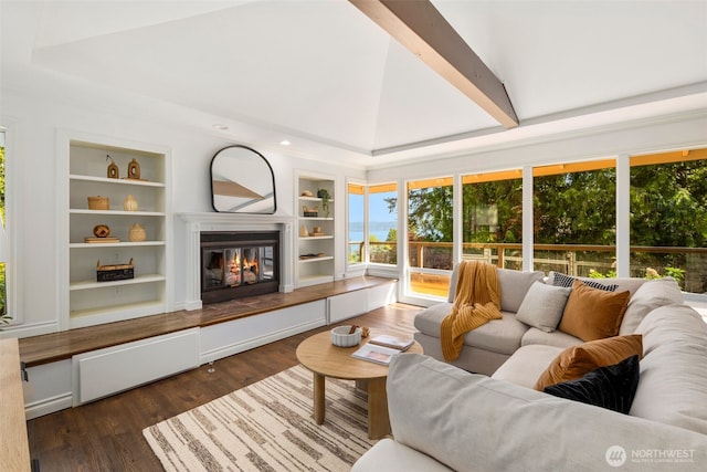 16939 SE 39th St, Bellevue, WA 98008 - living area with built in shelves, a glass covered fireplace, dark wood finished floors, and high vaulted ceiling