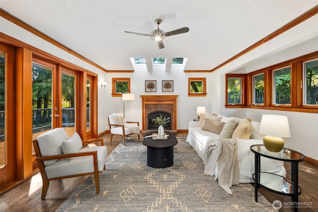 16939 SE 39th St, Bellevue, WA 98008 - living room featuring baseboards, a ceiling fan, wood finished floors, crown molding, and a skylight