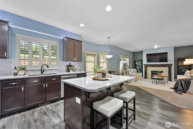 23804 17th Pl W, Bothell, WA 98021 - kitchen with a sink, dishwasher, a kitchen breakfast bar, wood finished floors, and dark brown cabinets