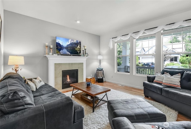 8354 22nd St NE, Lake Stevens, WA 98258 - living area with healthy amount of natural light, light wood-type flooring, a tiled fireplace, and recessed lighting