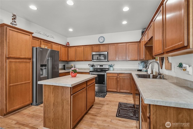 8354 22nd St NE, Lake Stevens, WA 98258 - kitchen with stainless steel appliances, light countertops, light wood finished floors, brown cabinetry, and recessed lighting