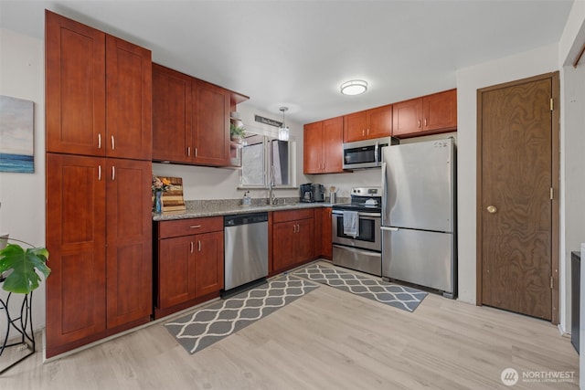 12812 62nd St Unit C-3, Gig Harbor, WA 98332 - kitchen with stainless steel appliances, light wood finished floors, and pendant lighting