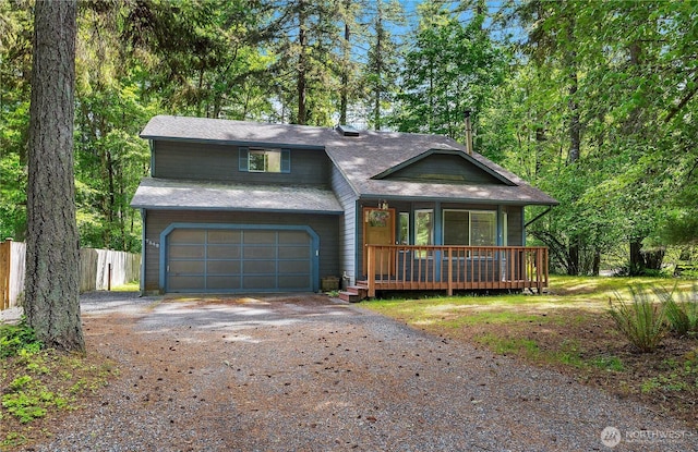 7549 Siskin Dr SE, Olympia, WA 98513 - view of front of home with dirt driveway, a porch, an attached garage, and a shingled roof