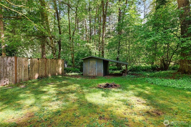 7549 Siskin Dr SE, Olympia, WA 98513 - view of yard featuring a fire pit and a forest view