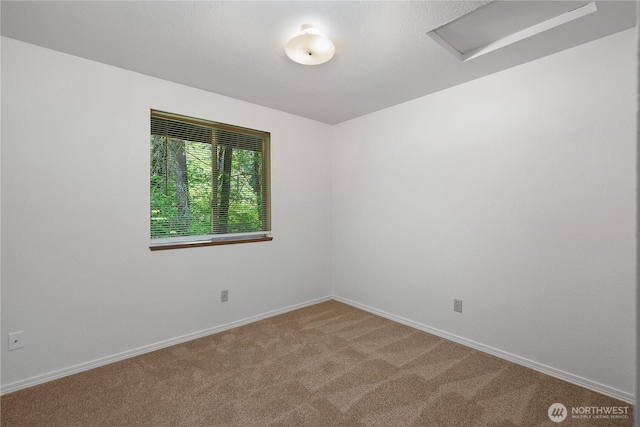 7549 Siskin Dr SE, Olympia, WA 98513 - unfurnished room featuring attic access, light carpet, and baseboards