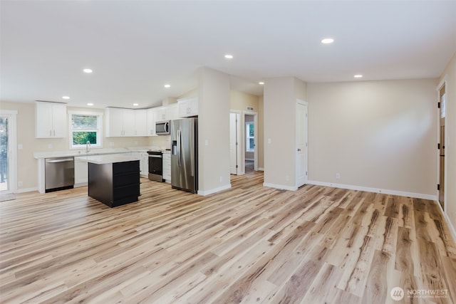 270 Granat St, Port Orchard, WA 98366 - kitchen featuring stainless steel appliances, light countertops, a sink, open floor plan, and light wood-style floors