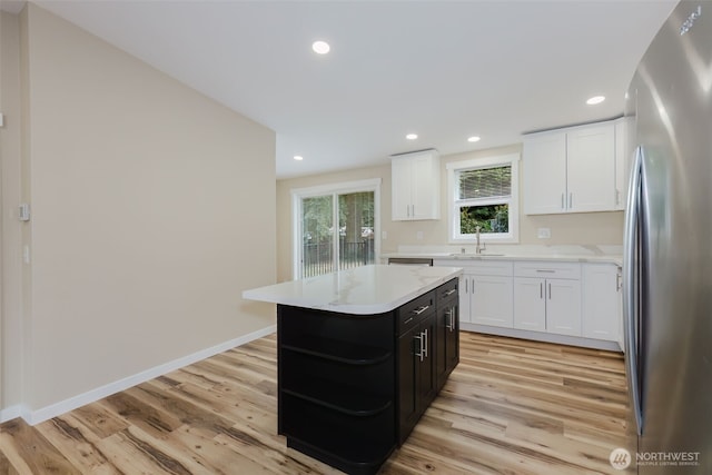 270 Granat St, Port Orchard, WA 98366 - kitchen featuring freestanding refrigerator, a sink, white cabinets, light countertops, and dark cabinets