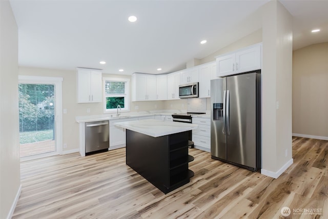 270 Granat St, Port Orchard, WA 98366 - kitchen featuring stainless steel appliances, light countertops, a sink, light wood finished floors, and white cabinetry