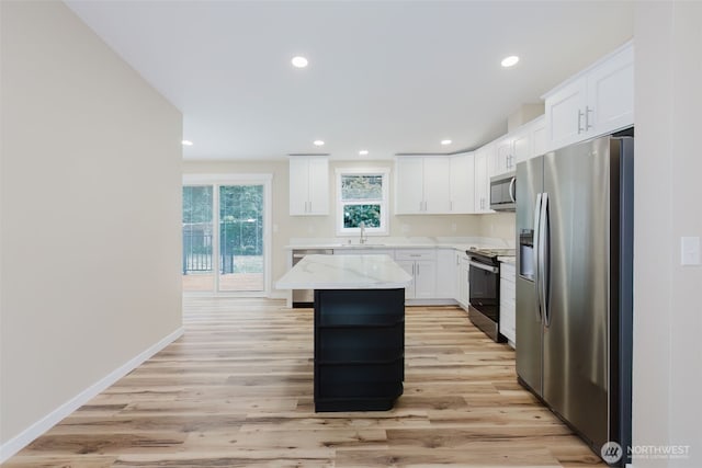 270 Granat St, Port Orchard, WA 98366 - kitchen featuring appliances with stainless steel finishes, recessed lighting, white cabinets, light wood-type flooring, and a kitchen island