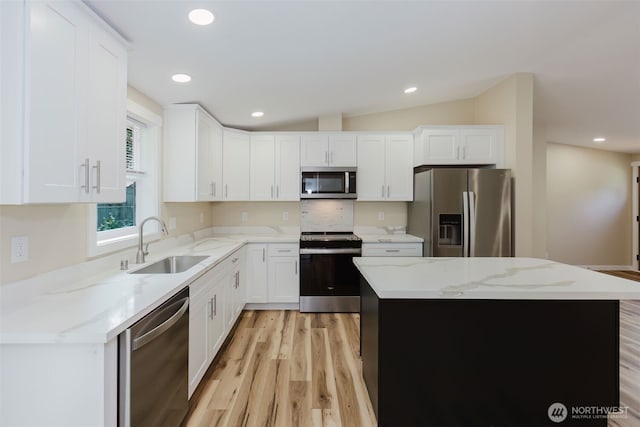 270 Granat St, Port Orchard, WA 98366 - kitchen featuring stainless steel appliances, a sink, light wood finished floors, a center island, and white cabinets