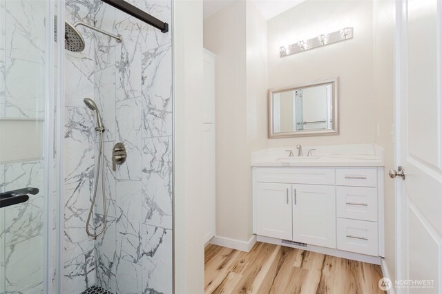 270 Granat St, Port Orchard, WA 98366 - bathroom with a marble finish shower, wood finished floors, vanity, and baseboards