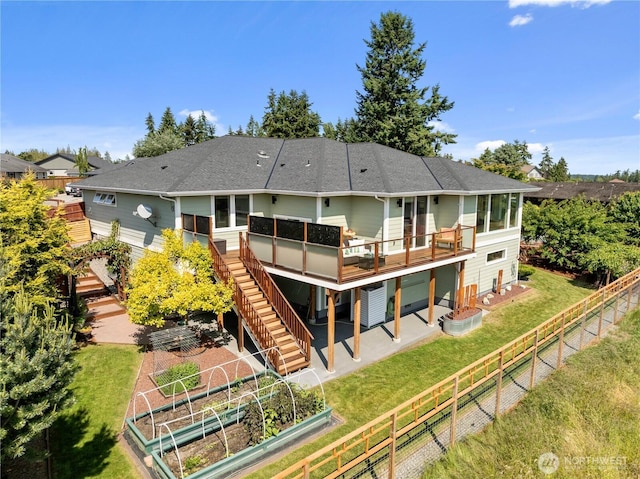 70 Ida Ct, Sequim, WA 98382 - rear view of property featuring a vegetable garden, a deck, stairway, and roof with shingles
