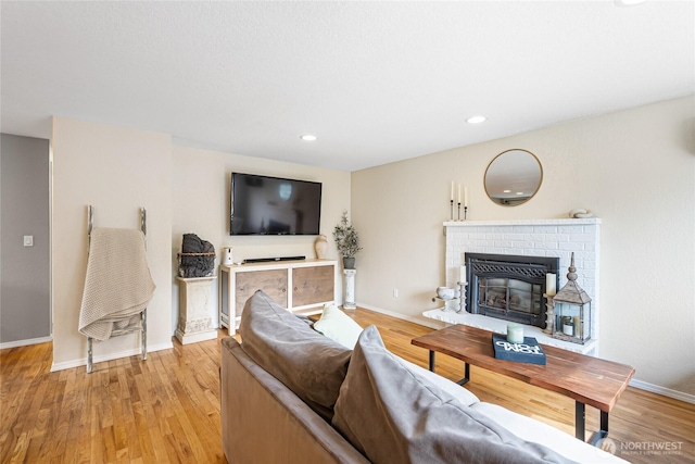 26600 Weaver Ave NW, Poulsbo, WA 98370 - living room featuring a fireplace, light wood-style flooring, and recessed lighting