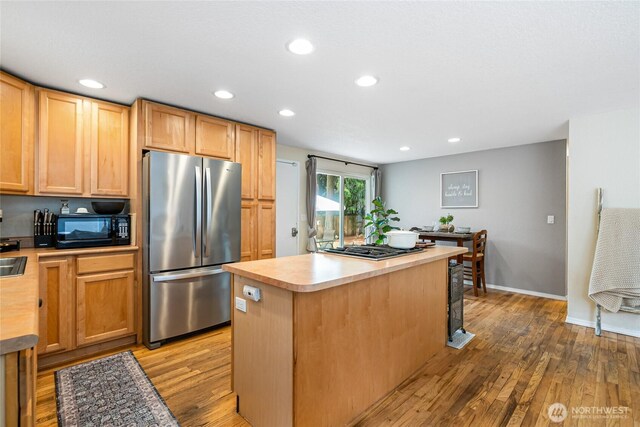 26600 Weaver Ave NW, Poulsbo, WA 98370 - kitchen featuring stainless steel appliances, light wood-style floors, a kitchen island, recessed lighting, and light countertops