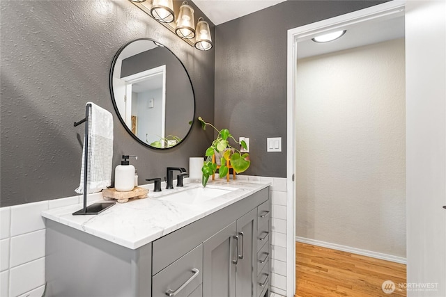 26600 Weaver Ave NW, Poulsbo, WA 98370 - bathroom featuring wood finished floors, vanity, and a textured wall
