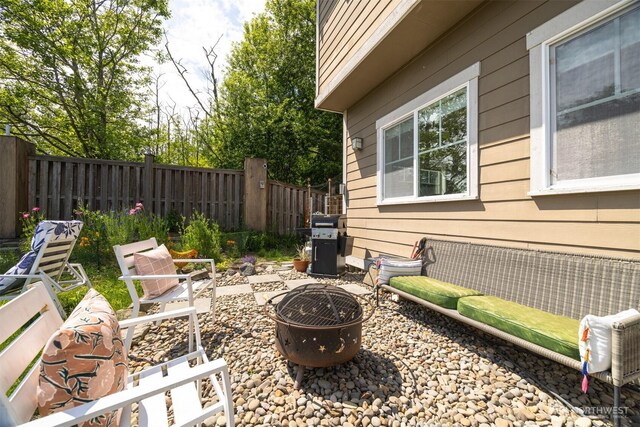 5695 Meadow View Dr, Ferndale, WA 98248 - fenced backyard featuring an outdoor fire pit, area for grilling, and a patio area