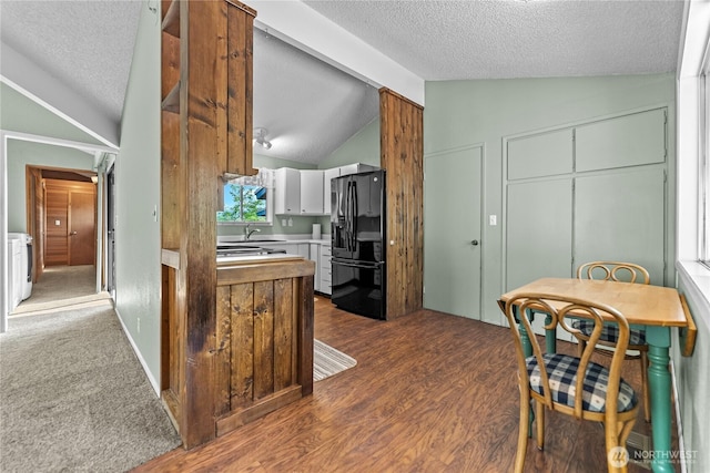 87 Vintin Rd, Carlton, WA 98814 - kitchen featuring black refrigerator with ice dispenser, vaulted ceiling, a textured ceiling, a sink, and light countertops