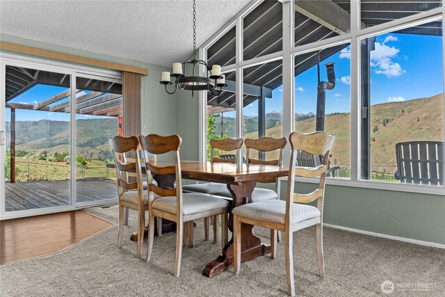 87 Vintin Rd, Carlton, WA 98814 - dining space with a chandelier, a mountain view, carpet, vaulted ceiling, and baseboards