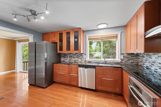 14208 NE 73rd St, Redmond, WA 98052 - kitchen with stainless steel appliances, a sink, brown cabinets, and light wood-type flooring