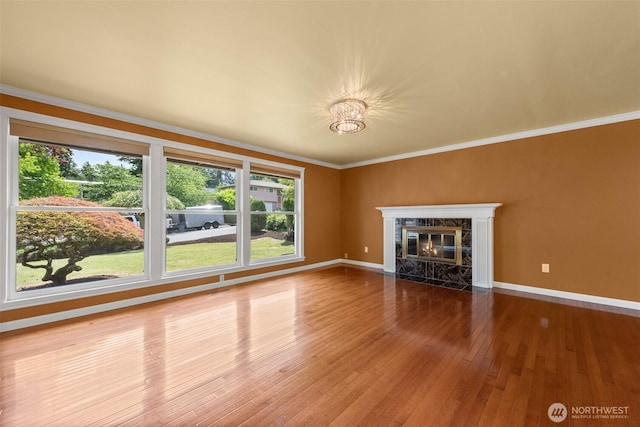 14208 NE 73rd St, Redmond, WA 98052 - unfurnished living room featuring hardwood / wood-style floors, baseboards, a high end fireplace, crown molding, and a chandelier