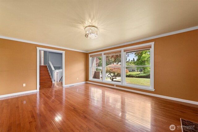 14208 NE 73rd St, Redmond, WA 98052 - empty room with baseboards, crown molding, hardwood / wood-style floors, and a chandelier