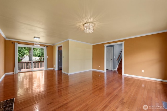 14208 NE 73rd St, Redmond, WA 98052 - empty room featuring a chandelier, light wood-style flooring, ornamental molding, baseboards, and stairway