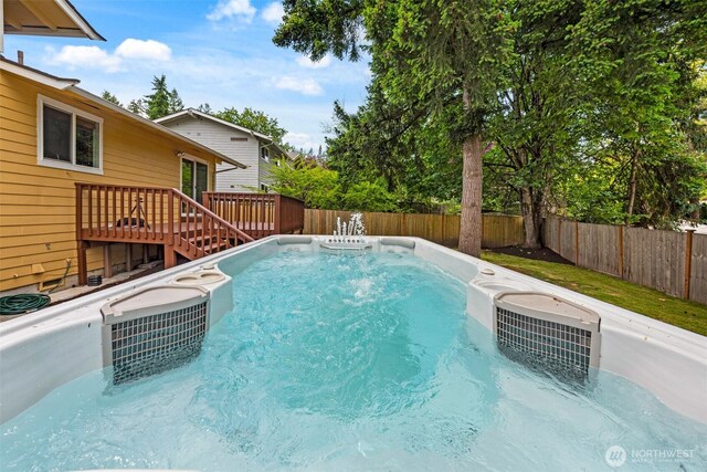 14208 NE 73rd St, Redmond, WA 98052 - view of swimming pool with a fenced backyard, a deck, a cooling unit, and a swimming pool