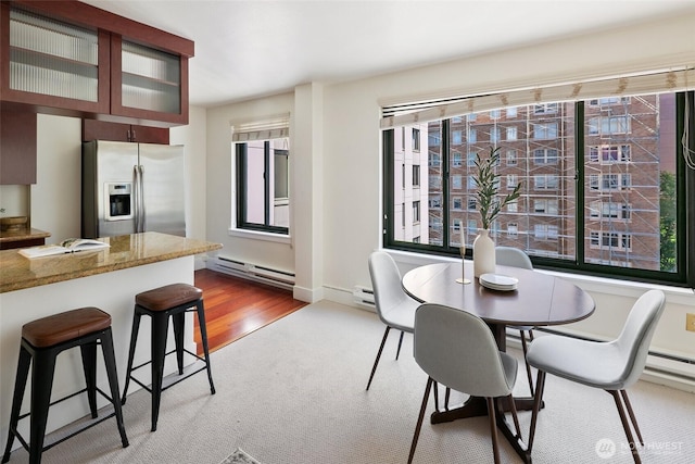 1105 Spring St Unit 712, Seattle, WA 98104 - dining area with a baseboard radiator, carpet, plenty of natural light, and baseboard heating