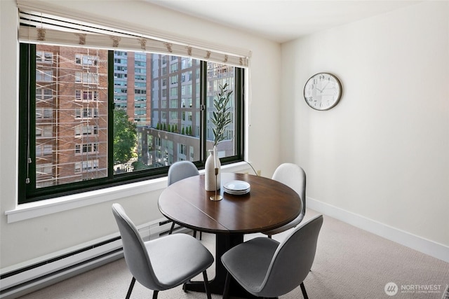 1105 Spring St Unit 712, Seattle, WA 98104 - dining area featuring a baseboard heating unit and carpet flooring