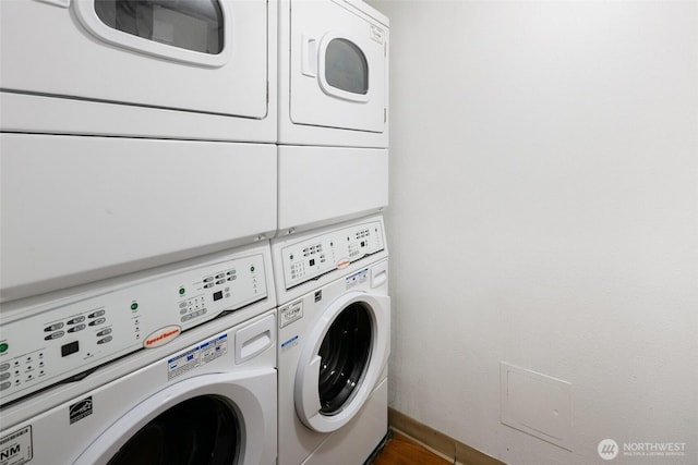 1105 Spring St Unit 712, Seattle, WA 98104 - washroom featuring separate washer and dryer and wood finished floors