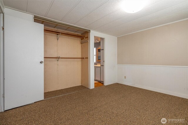 7515 Sunset Dr, Blaine, WA 98230 - unfurnished bedroom with carpet flooring, a wainscoted wall, a closet, and ensuite bath