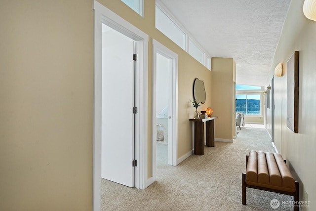 11613 SW Shawnee, Vashon, WA 98070 - hall featuring a textured ceiling, light colored carpet, and baseboards