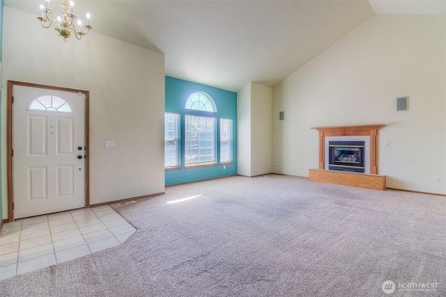 1620 S 68th Ave, Yakima, WA 98908 - foyer entrance featuring carpet flooring, a chandelier, high vaulted ceiling, a glass covered fireplace, and tile patterned floors