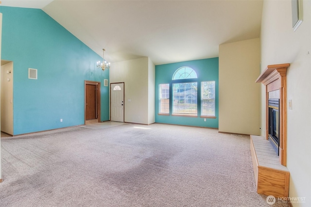 1620 S 68th Ave, Yakima, WA 98908 - unfurnished living room featuring high vaulted ceiling, a fireplace, carpet floors, and a chandelier
