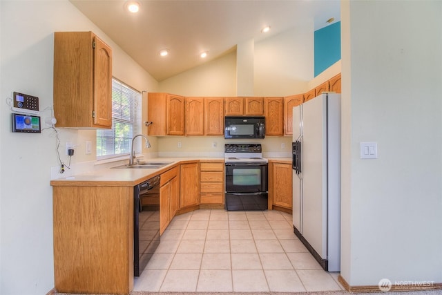 1620 S 68th Ave, Yakima, WA 98908 - kitchen featuring black appliances, light countertops, light tile patterned floors, lofted ceiling, and recessed lighting