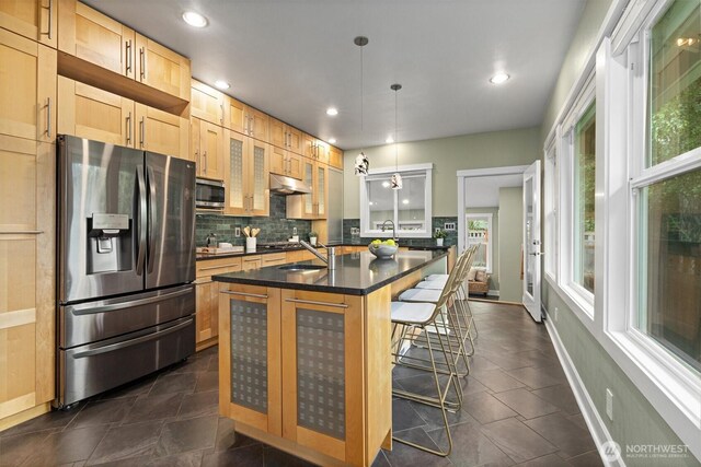 1218 NE 69th St, Seattle, WA 98115 - kitchen featuring appliances with stainless steel finishes, a sink, dark countertops, backsplash, and glass insert cabinets