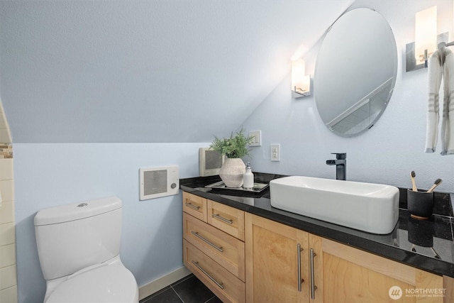 1218 NE 69th St, Seattle, WA 98115 - bathroom featuring vanity, toilet, lofted ceiling, and tile patterned floors