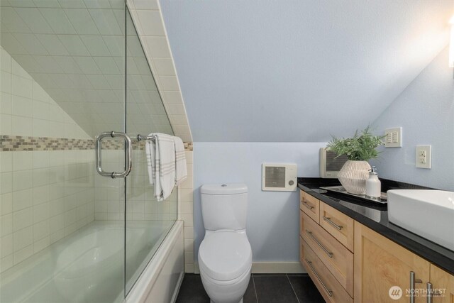 1218 NE 69th St, Seattle, WA 98115 - full bath with tile patterned floors, toilet, enclosed tub / shower combo, vanity, and vaulted ceiling