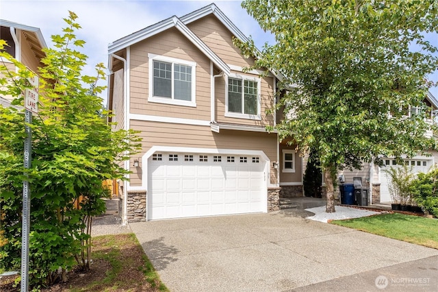 14808 26th Pl W Unit 2, Lynnwood, WA 98087 - view of front of home featuring stone siding, driveway, and a garage