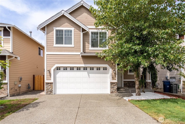 14808 26th Pl W Unit 2, Lynnwood, WA 98087 - view of front of property with stone siding, concrete driveway, and an attached garage